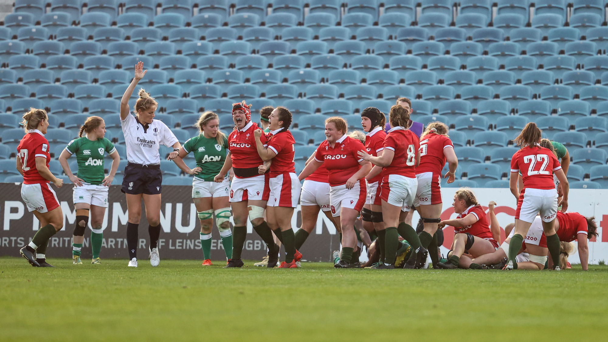 Donna Rose celebrates scoring a try with teammates